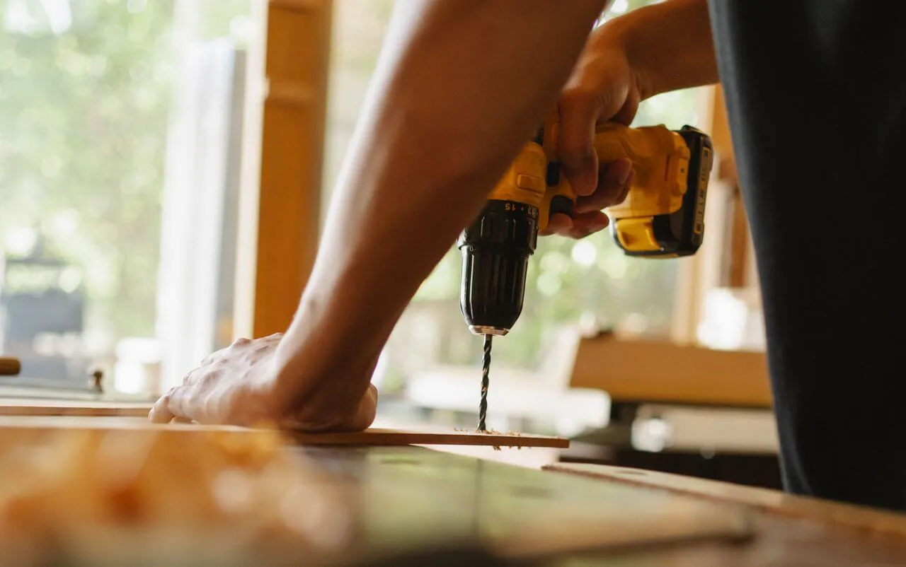 Handyman Fulham drilling a timber board for a repair job